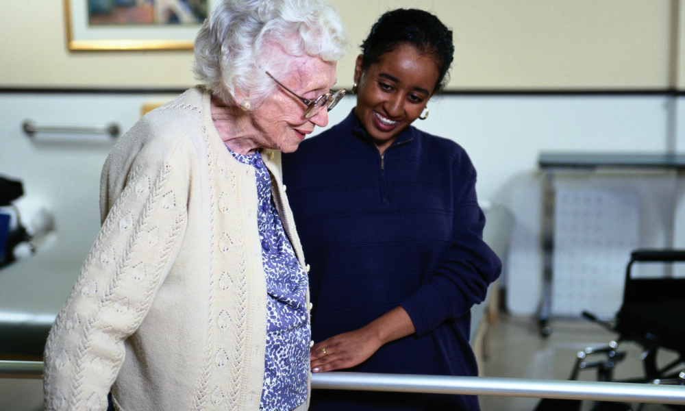 A carer and client sharing a warm moment at home